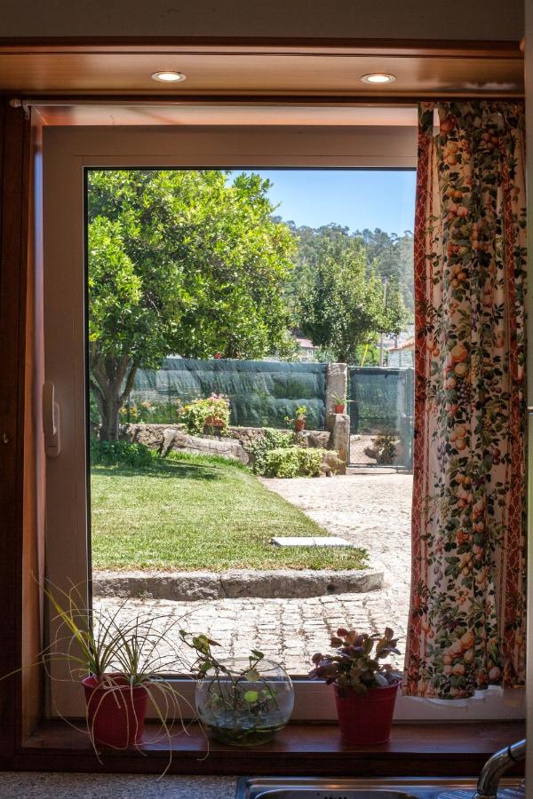 Janela interior emoldurada em madeira com vista para o jardim