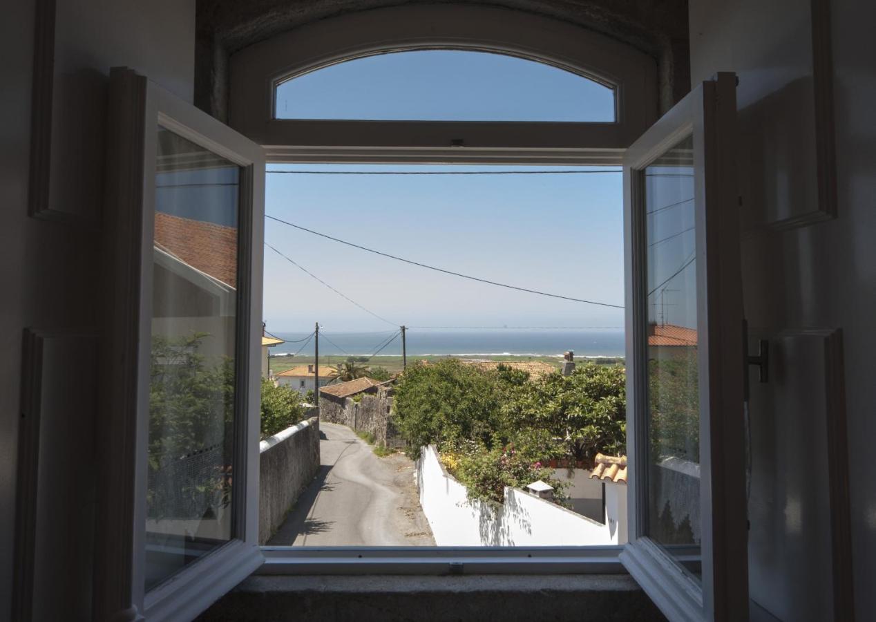 Vista do mar ao longe a partir de uma janela da casa