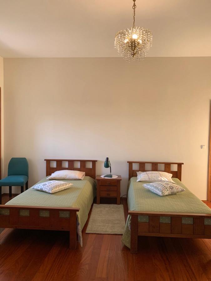 Quarto com duas camas individuais em madeira escura